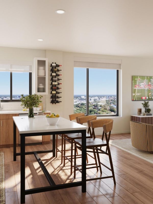 Sonder A modern kitchen and living room area featuring large windows with a panoramic view of the city skyline.