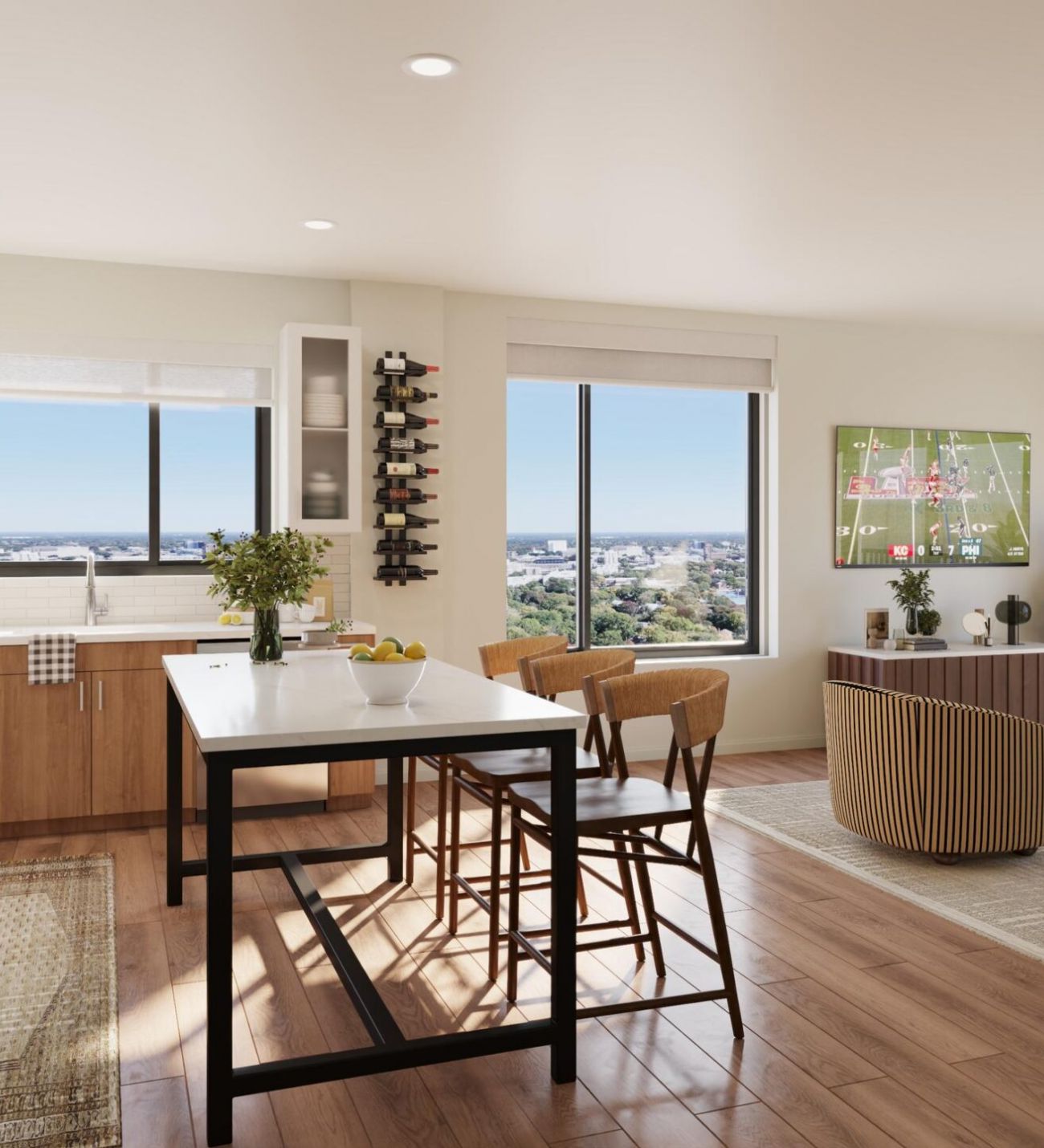 Bright, modern kitchen and dining area with large windows, wood floors, and contemporary furniture.