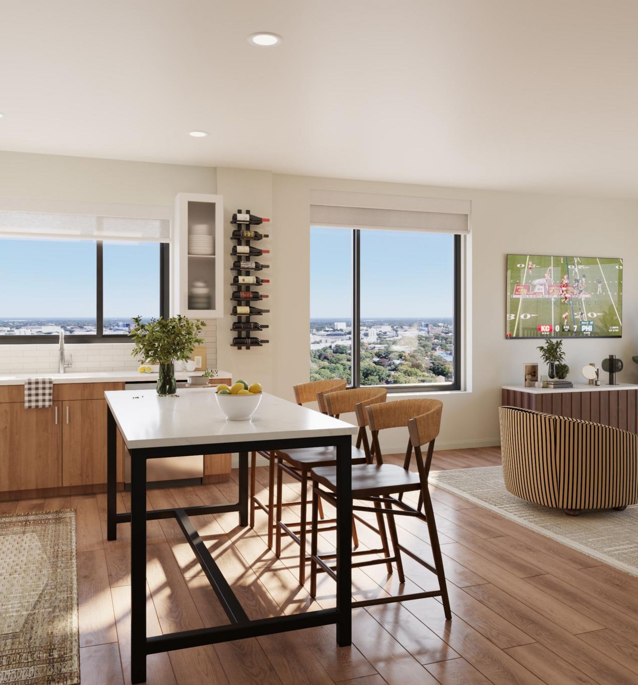 Sonder A modern kitchen and living room area featuring large windows with a panoramic view of the city skyline.