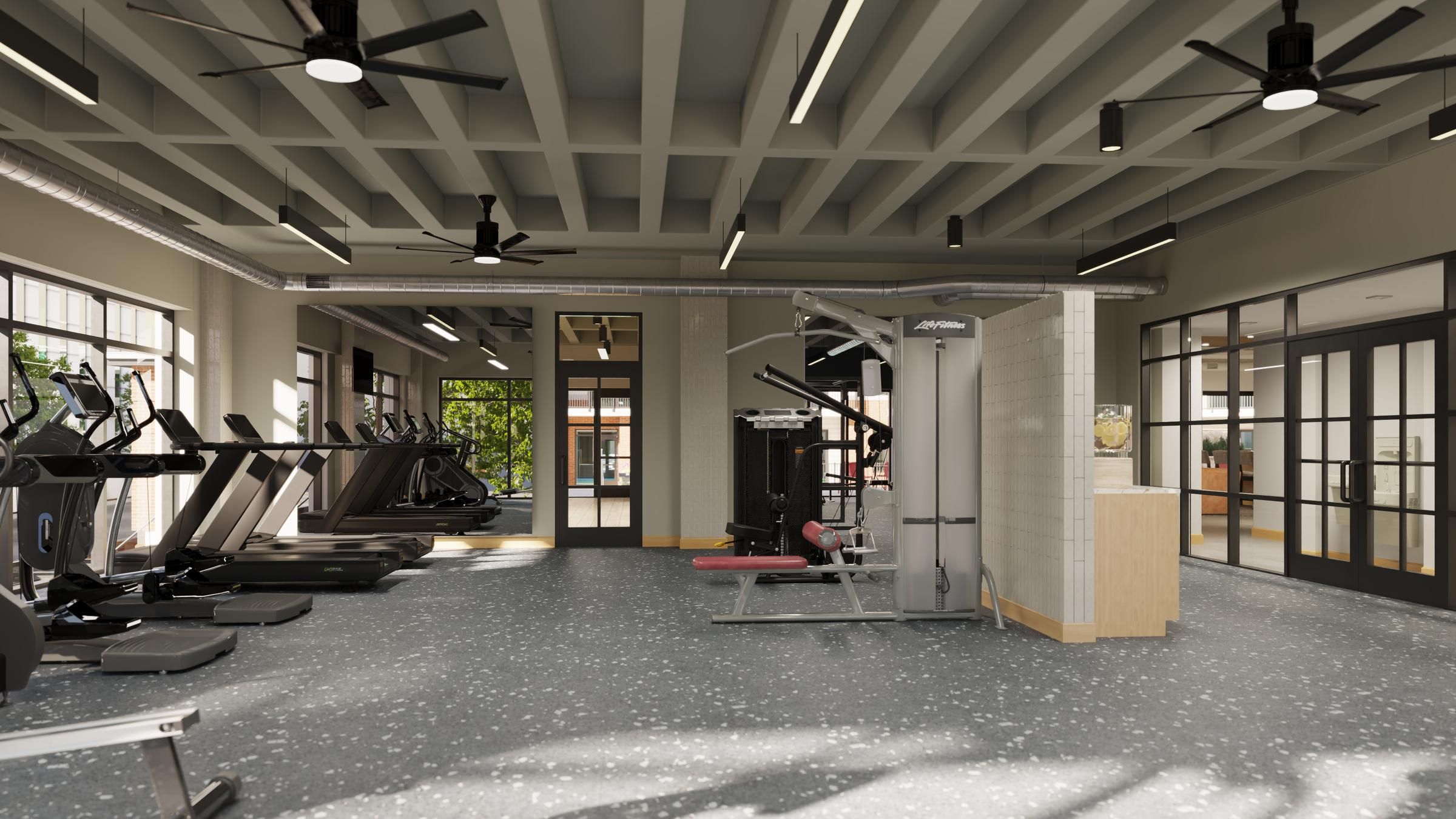 Sonder Interior of a gym showcasing several treadmills and diverse exercise equipment for fitness activities.